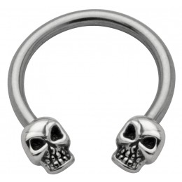 Side horseshoe piercing with skull motif