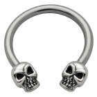 Side horseshoe piercing with skull motif