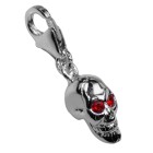 Pendant skull with devilishly glittering eyes to hang in a charm bracelet