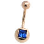 9k gold belly button piercing with dark blue crystal below