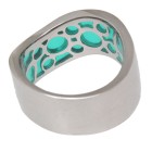 Steel ring with turquoise colored acrylic areas