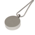 Round pendant made of high-gloss polished stainless steel with a golden heart